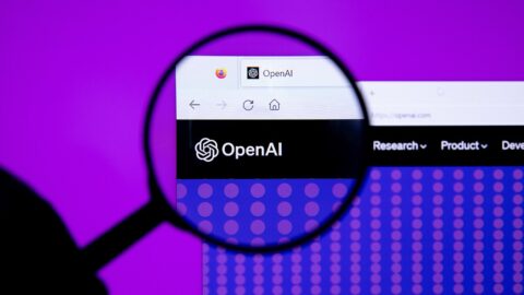 OpenAI logo seen under a magnifying glass