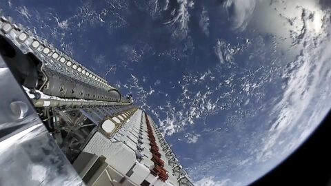 Starlink satellites deploying above Earth in orbit