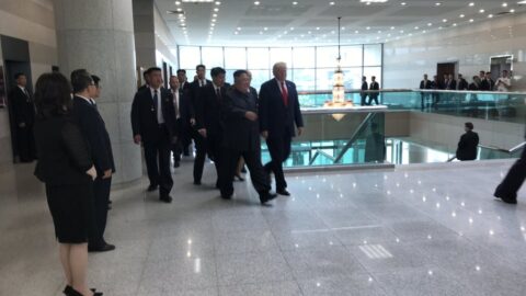 Donald Trump and Kim Jong-un walking with delegations after DMZ summit